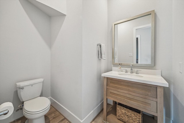 11011 Heartleaf Aster Way, Cypress, TX 77433 - half bath featuring vanity, toilet, wood finished floors, and baseboards