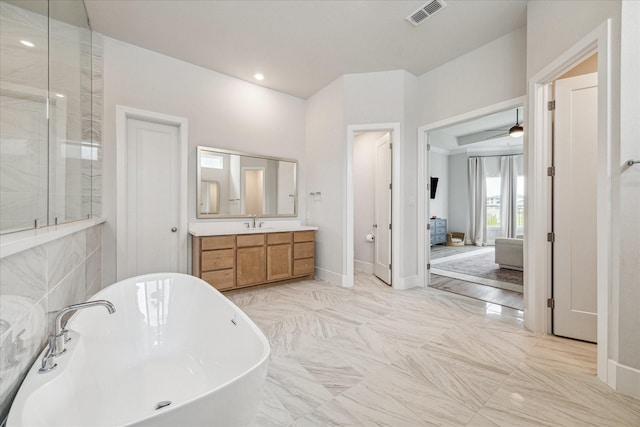 11011 Heartleaf Aster Way, Cypress, TX 77433 - full bathroom with a freestanding tub, vanity, a shower with door, marble finish floors, and baseboards
