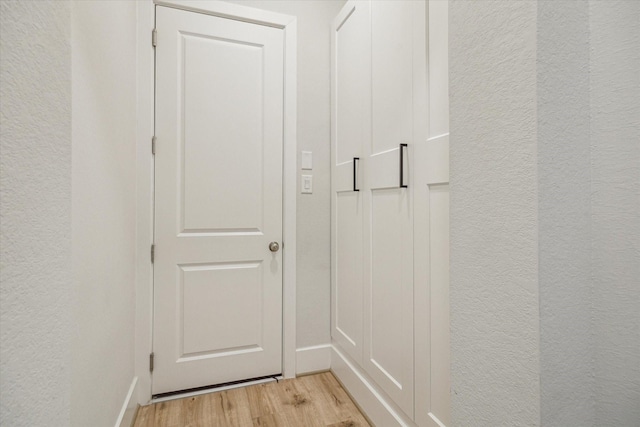 11011 Heartleaf Aster Way, Cypress, TX 77433 - entryway featuring light wood-style floors, a textured wall, and baseboards