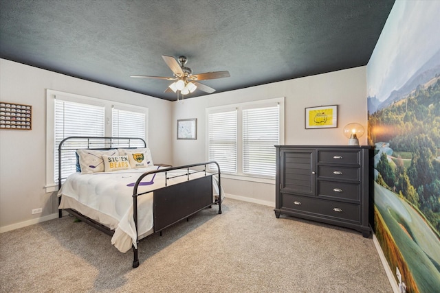 711 S Tesch St, Bellville, TX 77418 - bedroom featuring baseboards, light carpet, a ceiling fan, and a textured ceiling