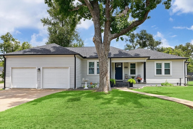 711 S Tesch St, Bellville, TX 77418 - ranch-style home featuring an attached garage, driveway, covered porch, a front lawn, and a shingled roof