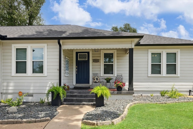 711 S Tesch St, Bellville, TX 77418 - view of exterior entry featuring roof with shingles, a porch, and crawl space
