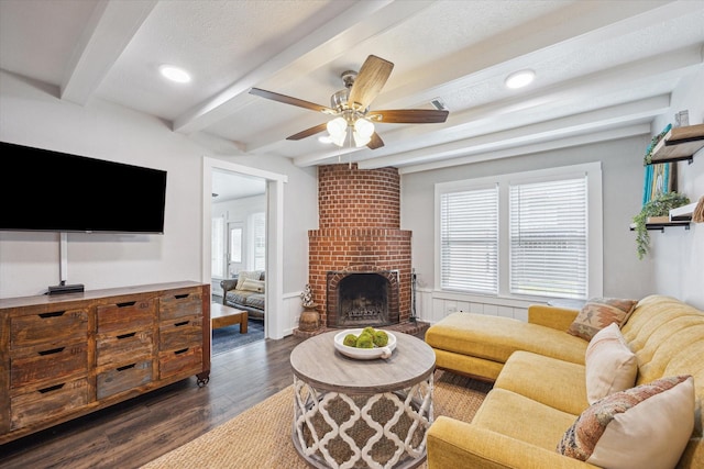 711 S Tesch St, Bellville, TX 77418 - living room with beam ceiling, dark wood-type flooring, ceiling fan, a brick fireplace, and recessed lighting