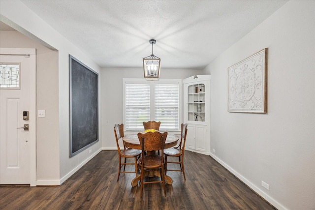 711 S Tesch St, Bellville, TX 77418 - dining area featuring dark wood-type flooring, baseboards, and a chandelier
