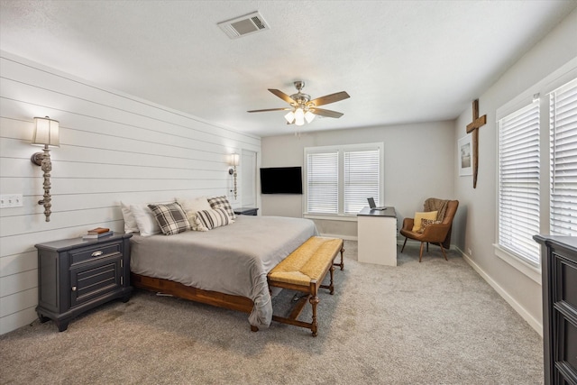 711 S Tesch St, Bellville, TX 77418 - bedroom featuring multiple windows, light carpet, ceiling fan, and baseboards