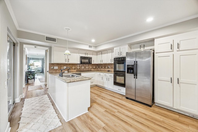 1433 Chardonnay Dr, Houston, TX 77077 - kitchen with black appliances, a sink, white cabinetry, light wood finished floors, and ornamental molding