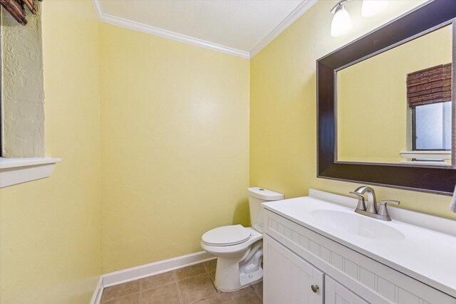 1433 Chardonnay Dr, Houston, TX 77077 - bathroom featuring ornamental molding, toilet, vanity, baseboards, and tile patterned flooring