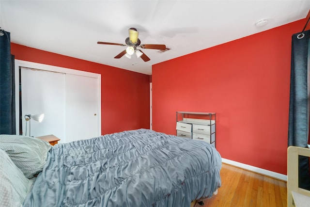 6601 Roos Rd, Houston, TX 77074 - bedroom featuring wood finished floors, a closet, a ceiling fan, and baseboards
