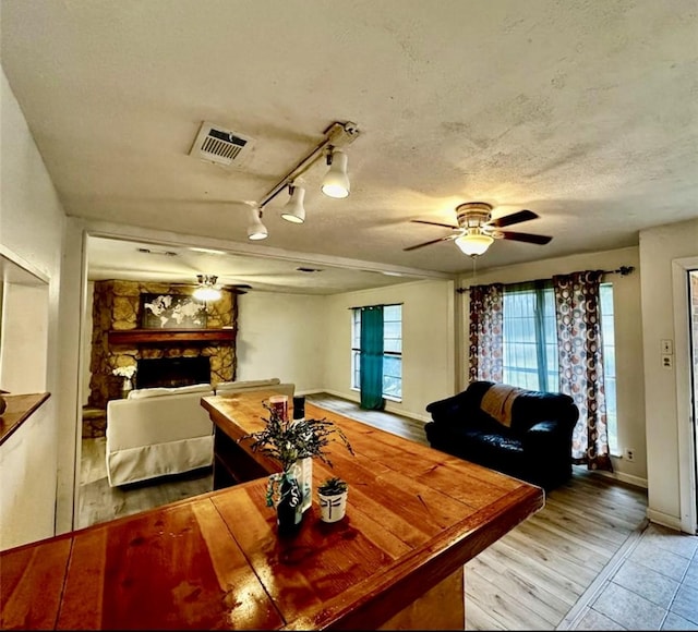 1008 Brockman St, Sweeny, TX 77480 - living area featuring a ceiling fan, a fireplace, baseboards, and wood finished floors