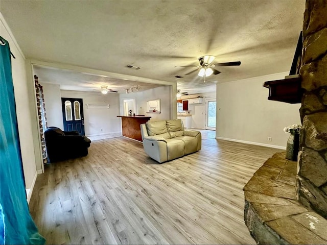 1008 Brockman St, Sweeny, TX 77480 - living area with ceiling fan, wood finished floors, baseboards, and a textured ceiling