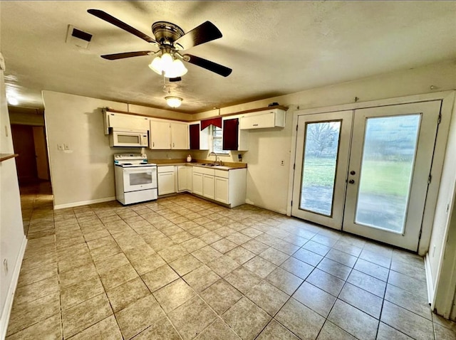 1008 Brockman St, Sweeny, TX 77480 - kitchen with white appliances, a sink, healthy amount of natural light, and french doors