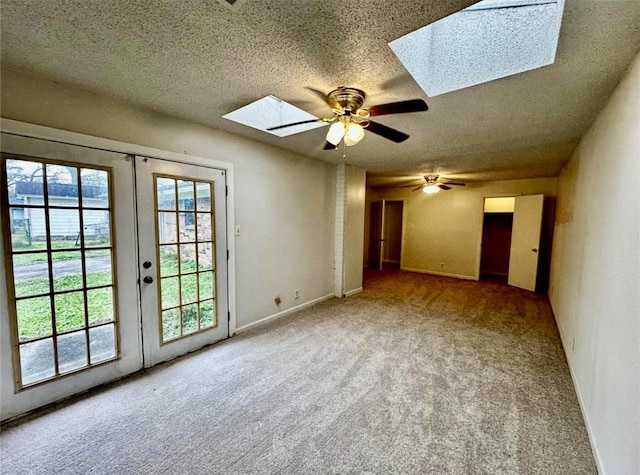 1008 Brockman St, Sweeny, TX 77480 - unfurnished room with a skylight, carpet, french doors, a textured ceiling, and ceiling fan