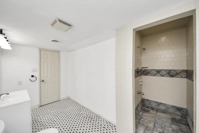 6304 Crab Orchard Rd, Houston, TX 77057 - full bathroom with a tile shower, vanity, and baseboards