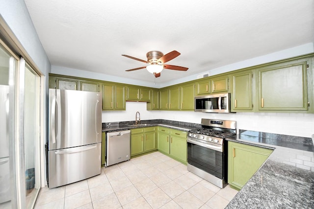 6304 Crab Orchard Rd, Houston, TX 77057 - kitchen with stainless steel appliances, green cabinets, a sink, ceiling fan, and light tile patterned floors