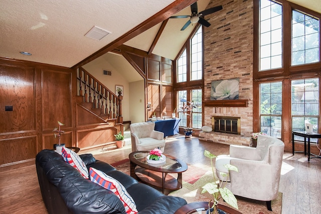 1610 Chapelwood Ln, Richmond, TX 77406 - living area featuring high vaulted ceiling, wood finished floors, stairway, a fireplace, and a ceiling fan