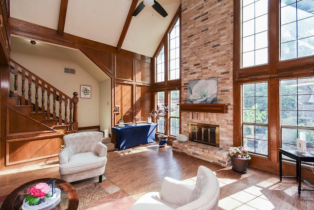 1610 Chapelwood Ln, Richmond, TX 77406 - living room with high vaulted ceiling, wood finished floors, beamed ceiling, a fireplace, and ceiling fan