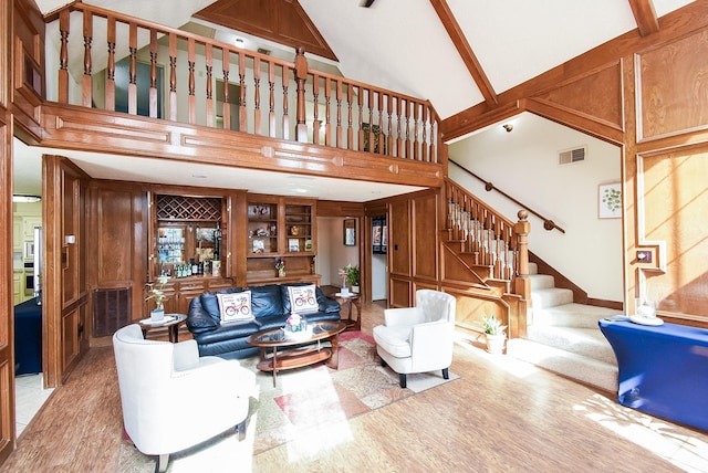 1610 Chapelwood Ln, Richmond, TX 77406 - living area with high vaulted ceiling, stairway, light wood-type flooring, wood walls, and built in shelves