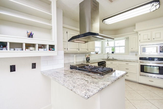1610 Chapelwood Ln, Richmond, TX 77406 - kitchen featuring stainless steel appliances, island range hood, a sink, tasteful backsplash, and light stone countertops