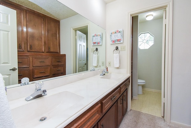 1610 Chapelwood Ln, Richmond, TX 77406 - full bath with toilet, double vanity, and baseboards