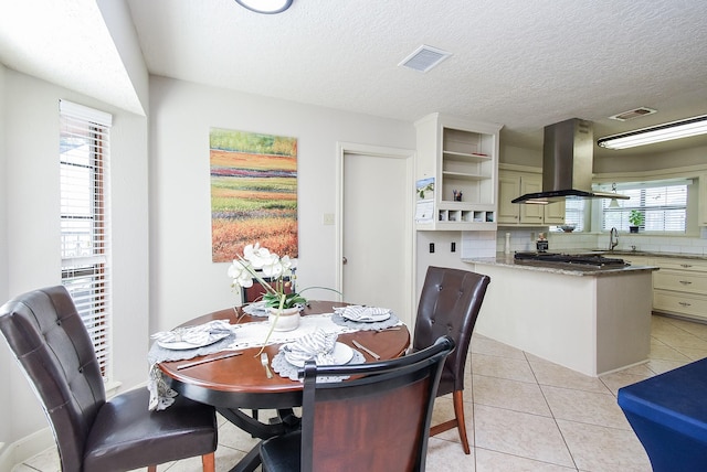 1610 Chapelwood Ln, Richmond, TX 77406 - dining room featuring light tile patterned flooring and a textured ceiling