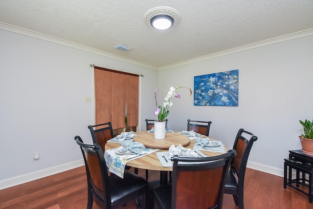 1610 Chapelwood Ln, Richmond, TX 77406 - dining area with dark wood-style flooring, baseboards, a textured ceiling, and ornamental molding