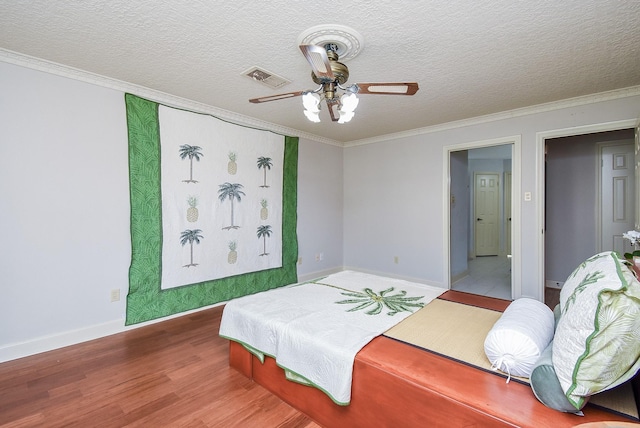1610 Chapelwood Ln, Richmond, TX 77406 - bedroom with wood finished floors, crown molding, baseboards, a textured ceiling, and a ceiling fan