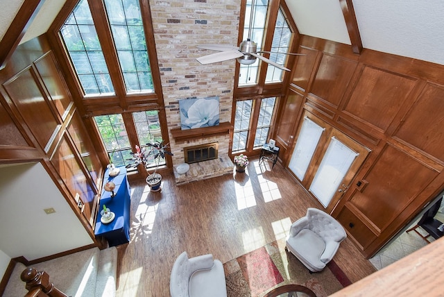 1610 Chapelwood Ln, Richmond, TX 77406 - living room featuring a high ceiling, a large fireplace, ceiling fan, and wood finished floors