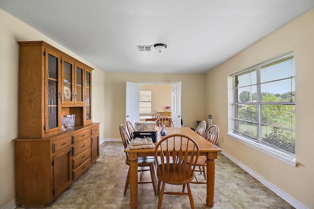 11221 State Highway 65, Winnie, TX 77665 - dining room featuring baseboards