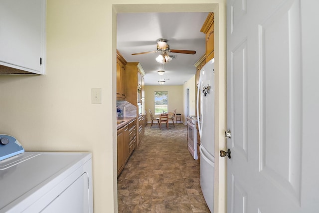 11221 State Highway 65, Winnie, TX 77665 - laundry room with washer / dryer, a ceiling fan, and stone finish flooring