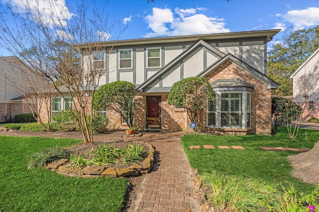 5218 Springton Ln, Spring, TX 77379 - tudor-style house featuring brick siding, stucco siding, and a front yard