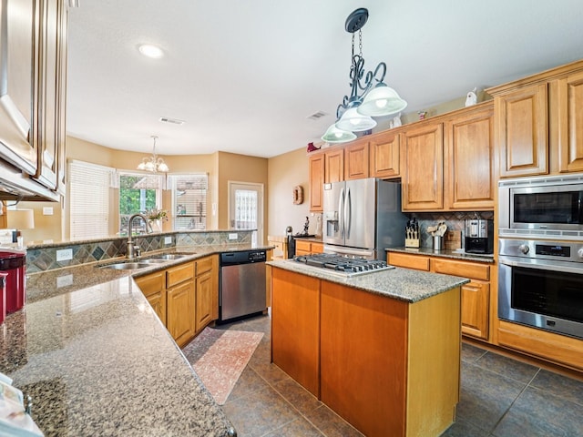 1003 Commons Waterway Dr, Huffman, TX 77336 - kitchen with appliances with stainless steel finishes, a sink, a chandelier, decorative backsplash, and stone countertops
