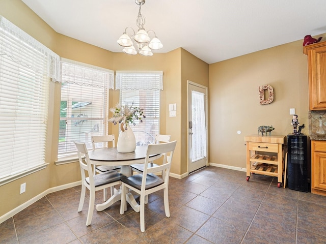 1003 Commons Waterway Dr, Huffman, TX 77336 - dining area with a chandelier, plenty of natural light, dark tile patterned floors, and baseboards