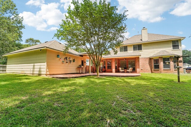 1003 Commons Waterway Dr, Huffman, TX 77336 - rear view of house with a patio, a yard, a chimney, and brick siding
