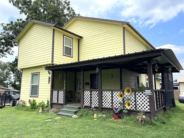 120 N 10th Ave, Teague, TX 75860 - view of front of home with covered porch and a front lawn