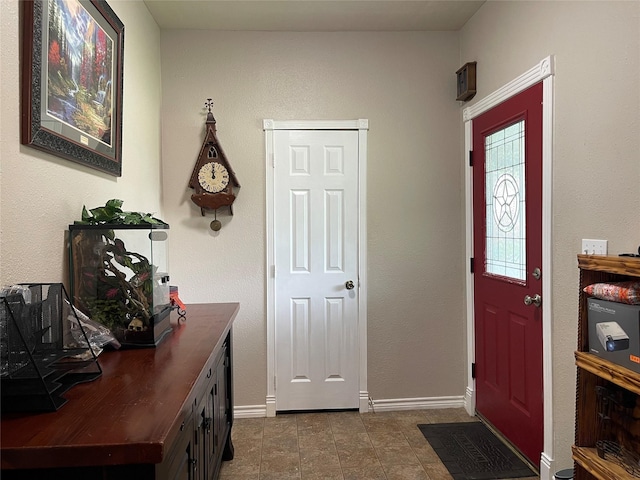 120 N 10th Ave, Teague, TX 75860 - foyer entrance featuring dark tile patterned flooring and baseboards