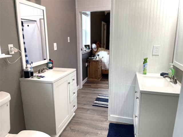 120 N 10th Ave, Teague, TX 75860 - bathroom featuring vanity, toilet, and wood finished floors