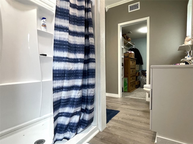 120 N 10th Ave, Teague, TX 75860 - bathroom with wood finished floors, crown molding, and baseboards