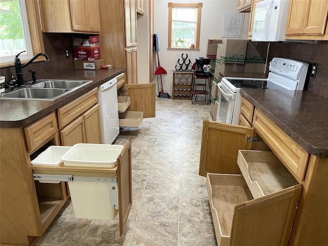120 N 10th Ave, Teague, TX 75860 - kitchen with white appliances, a sink, dark countertops, and light stone finish flooring