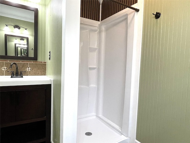 120 N 10th Ave, Teague, TX 75860 - bathroom with a shower stall, backsplash, vanity, and ornamental molding