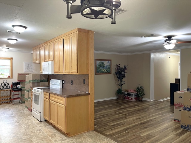 120 N 10th Ave, Teague, TX 75860 - kitchen featuring white appliances, crown molding, dark countertops, ceiling fan, and tasteful backsplash