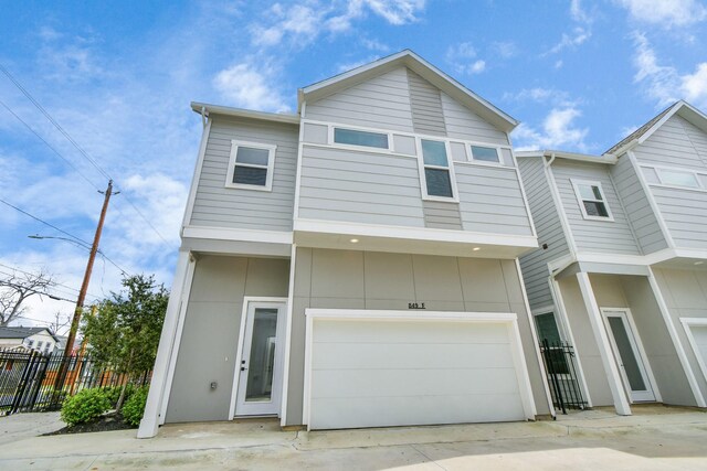 849 Mansfield St Unit E, Houston, TX 77091 - view of front of house with a garage and driveway