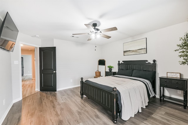 21100 Titian Dr, Magnolia, TX 77355 - bedroom with light wood finished floors, baseboards, and ceiling fan