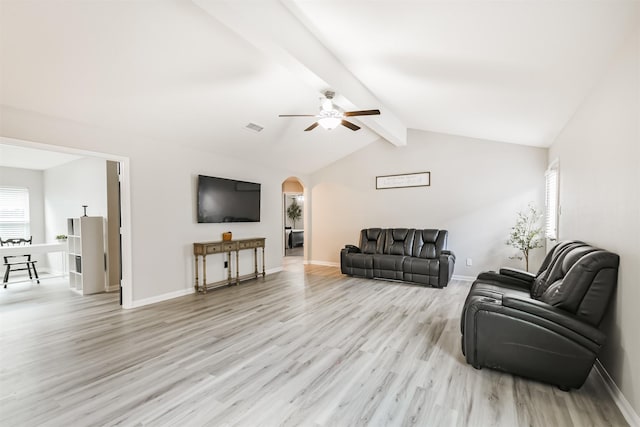21100 Titian Dr, Magnolia, TX 77355 - living room with light wood finished floors, arched walkways, a ceiling fan, and baseboards