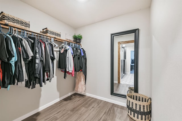21100 Titian Dr, Magnolia, TX 77355 - walk in closet featuring wood finished floors