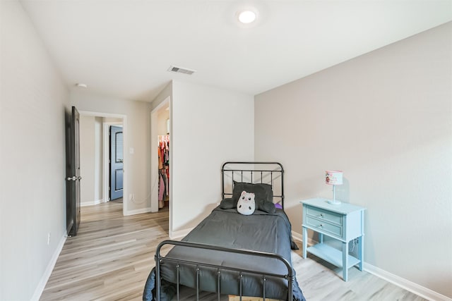 21100 Titian Dr, Magnolia, TX 77355 - bedroom featuring light wood-style flooring and baseboards