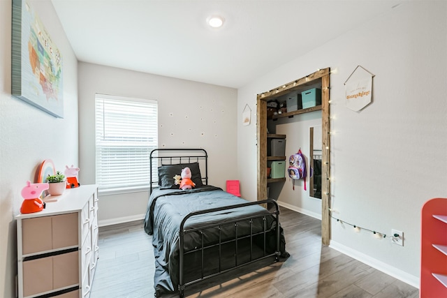 21100 Titian Dr, Magnolia, TX 77355 - bedroom with wood finished floors and baseboards
