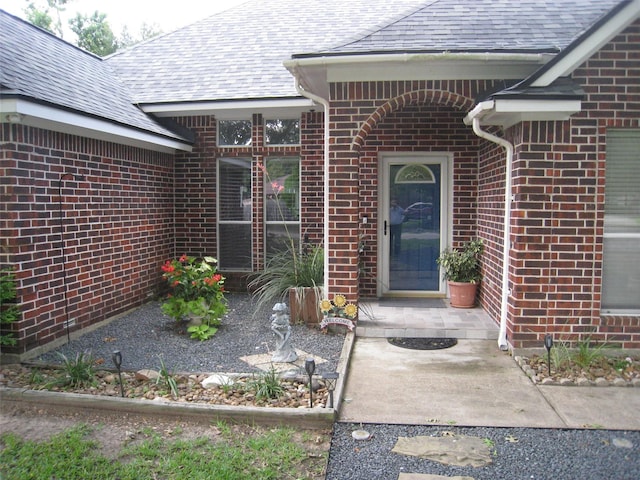 115 Texarkana Dr, Magnolia, TX 77354 - property entrance with brick siding and roof with shingles