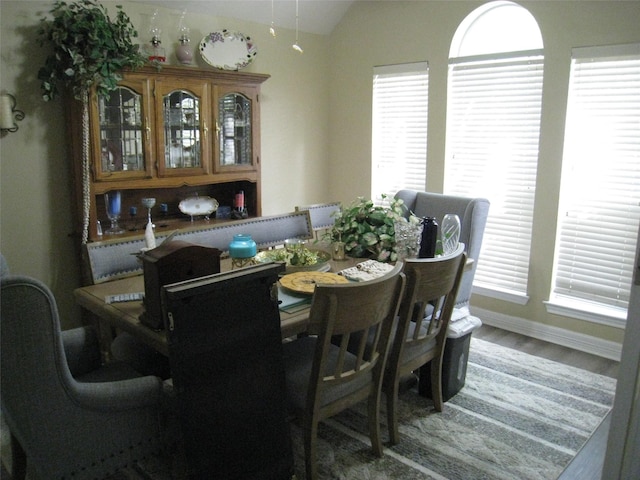 115 Texarkana Dr, Magnolia, TX 77354 - dining area featuring wood finished floors, vaulted ceiling, and baseboards
