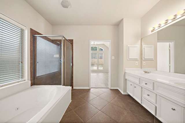 2507 Abernathy Glen Ct, Houston, TX 77014 - bathroom featuring double vanity, a tub with jets, a stall shower, and tile patterned flooring