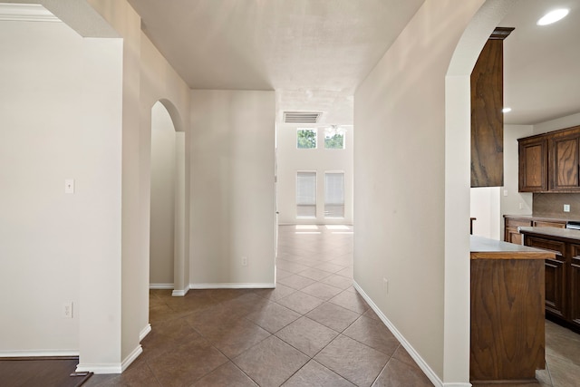 2507 Abernathy Glen Ct, Houston, TX 77014 - corridor with arched walkways, tile patterned floors, and recessed lighting